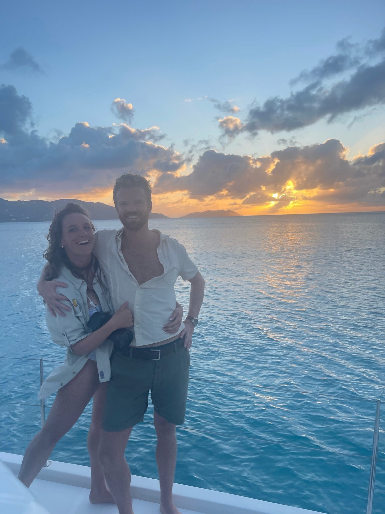 Two guests at the stern as the sun sets