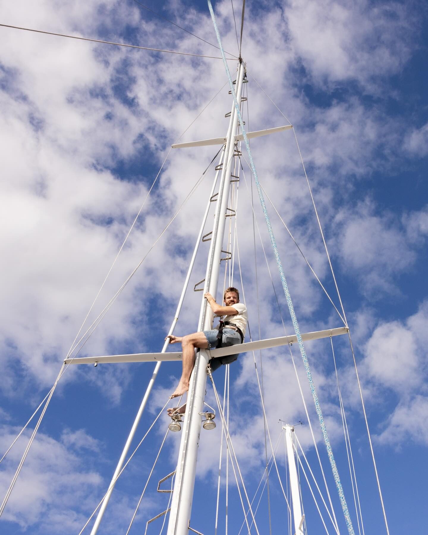 Mike aloft in Starchaser’s rigging against a blue sky
