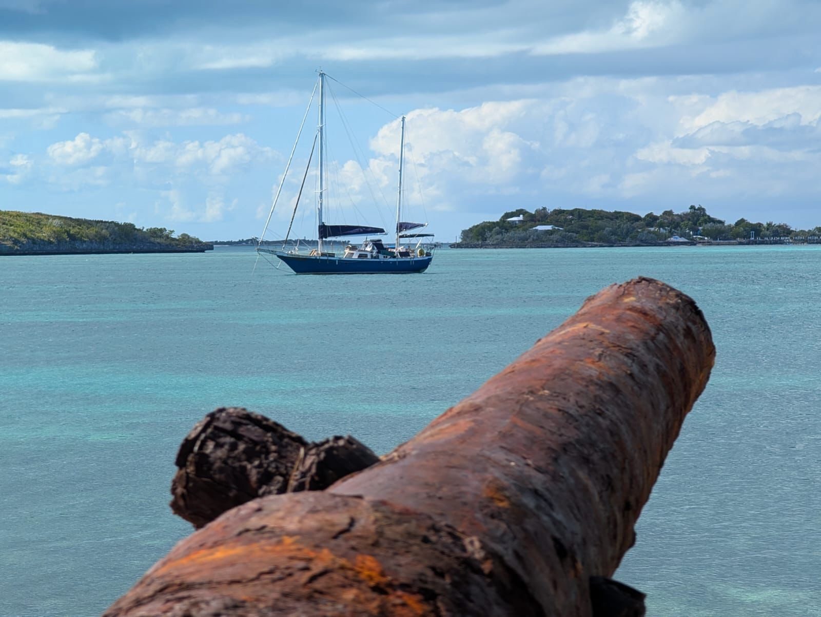 Starchaser at anchor beyond an old cannon