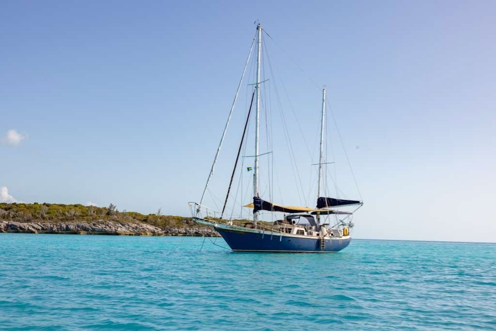 Starchaser anchored off a beach